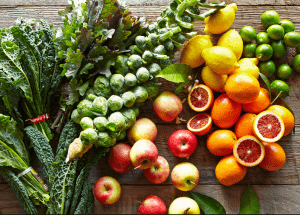 a group of fruits and vegetables on a wood surface Healthy Weight Loss Diets Merthyr Tydfil